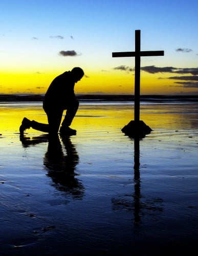 Kneeling Before The Cross