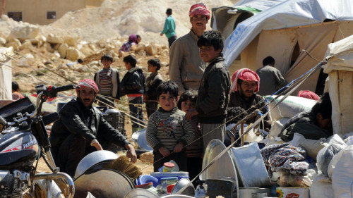 Syrian refugees who fled the violence from the Syrian town of Flita, near Yabroud, pose for a photograph at the border town of Arsal