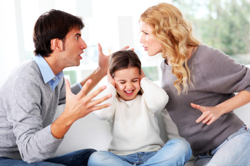 Couple fighting in front of child