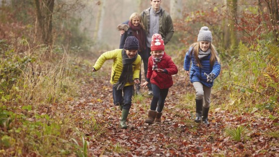 Family Walking Through Winter Woodland